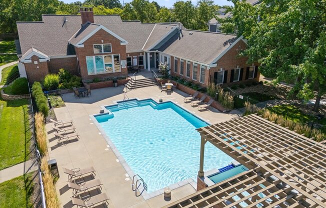 A large house with a pool in the backyard. at Somerset Oaks Apartment Homes, Olathe 66062