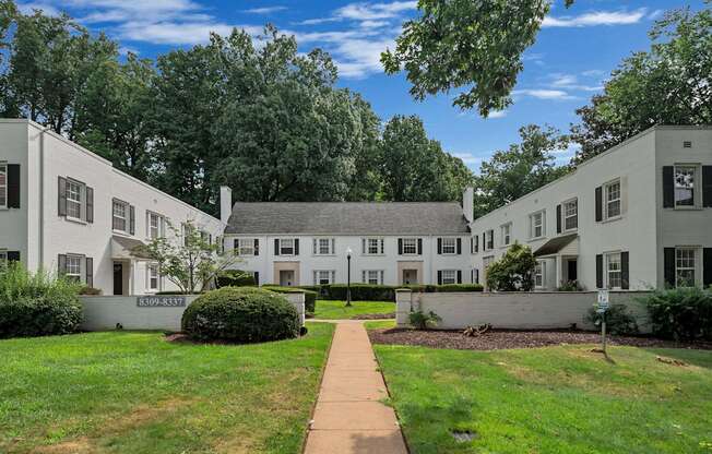 A white building with a sign that says "EXPANSION" in front of it.