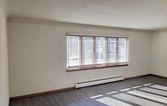 the living room of an empty house with a large window