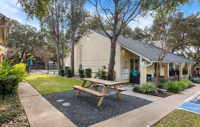 A small house with a picnic table in front.