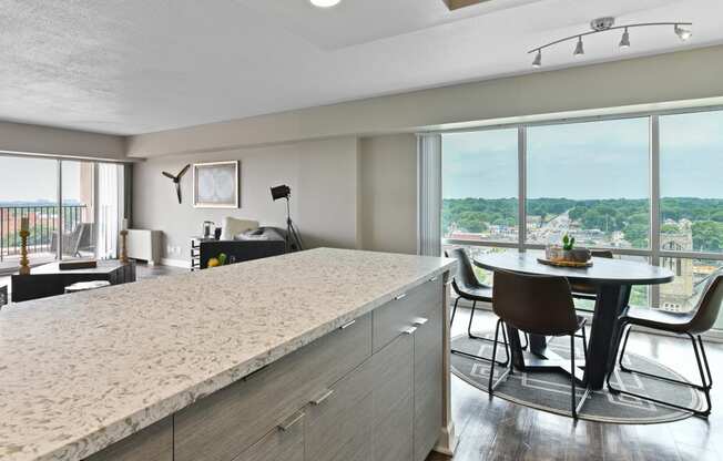 an open kitchen and dining room with a view of the city