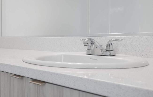 a white bathroom sink with a silver faucet