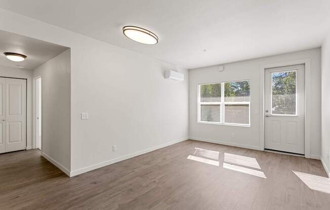 A room with a window and a door.