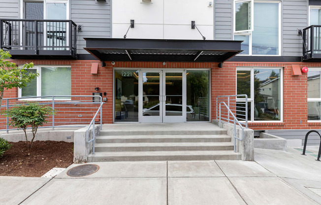 View of the front of the property entrance with a ramp and stairs leading up to the door at Arabella Apartment Homes, Washington