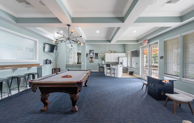 a game room with a pool table and a bar