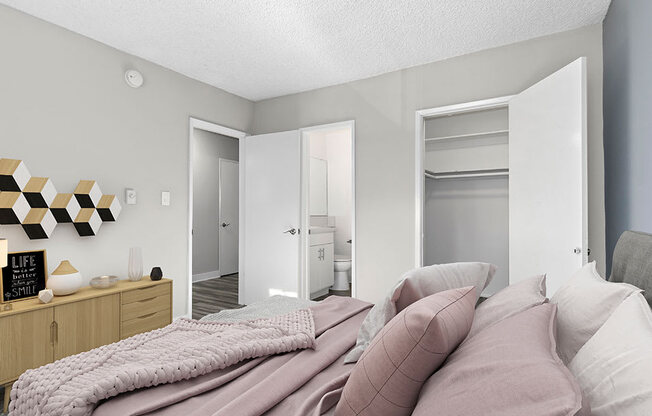 Carpeted bedroom with view of private closet and hall.