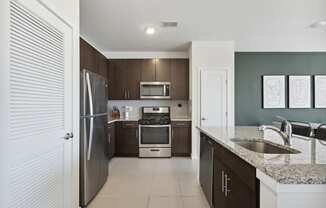 Modern kitchen with stainless steel appliances at The Lofts at Middlesex