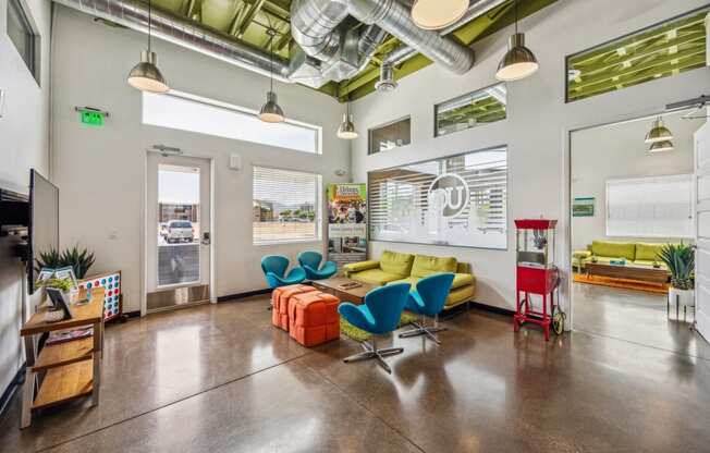 a living room with a yellow couch and blue chairs