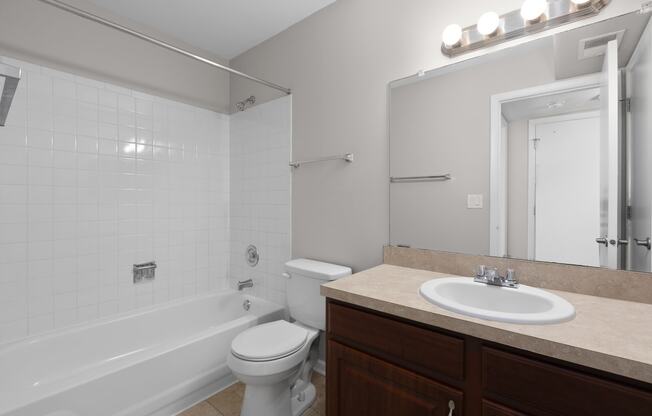 a bathroom with a sink toilet and a tub