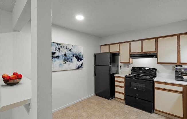 a kitchen with a stove and a refrigeratorat Millcreek Woods Apartments, Kansas, 66061