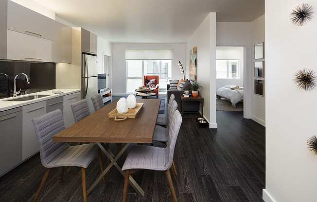 A modern kitchen with a dining table and chairs.