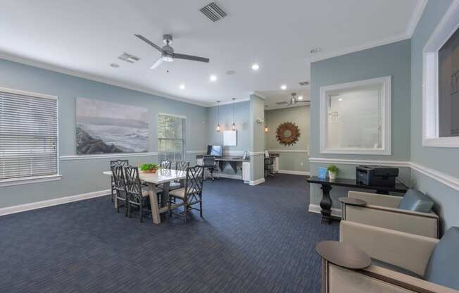 a conference room with a table and chairs and a ceiling fan