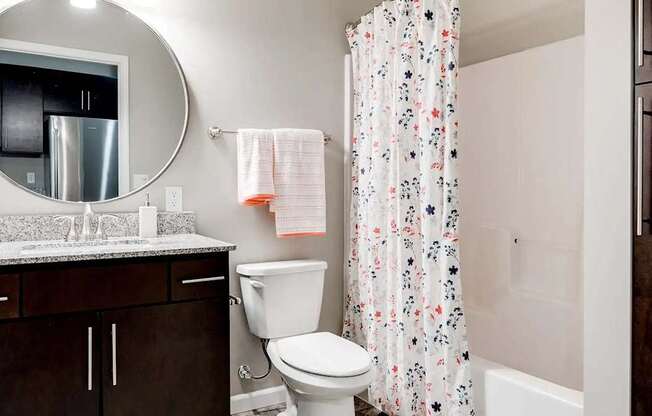 a bathroom with a shower and a toilet and a sink. Circle Pines, MN Lexington Lofts