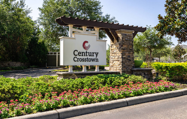 sign for the century crosstownhomes in front of a flowers