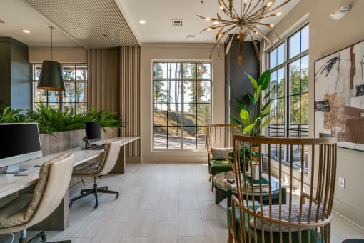 a home office with a desk and chairs and a large window