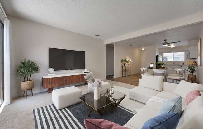 a living room with a white couch and a television