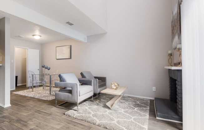 a living room with gray couches and a coffee table