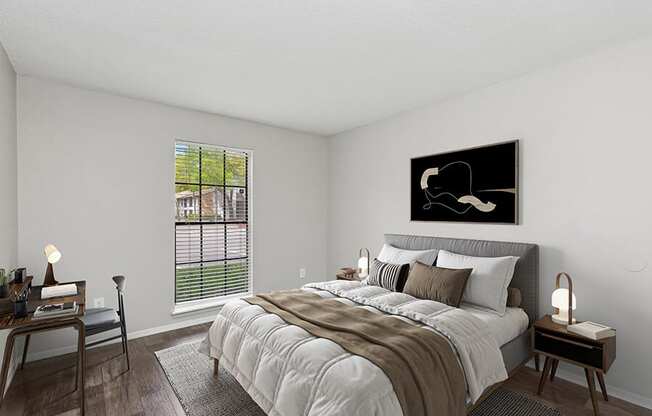 Model Bedroom with Wood-Style Flooring and Window View at Grand Pavilion Apartments in Tampa, FL.