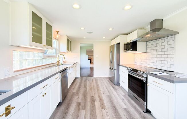 Beautiful recently remodeled 4 bed 2 bath home. Perfect for multi generational living with second kitchen in basement!