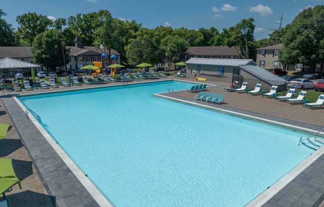 Louisville, KY Apartments For Rent - Enclave At Breckenridge - Large Pool With Spacious Sundeck, Lounge Chairs, And Umbrellas.