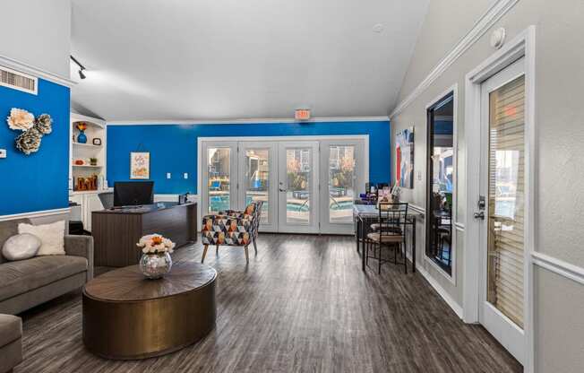 a living room with blue walls and a patio door