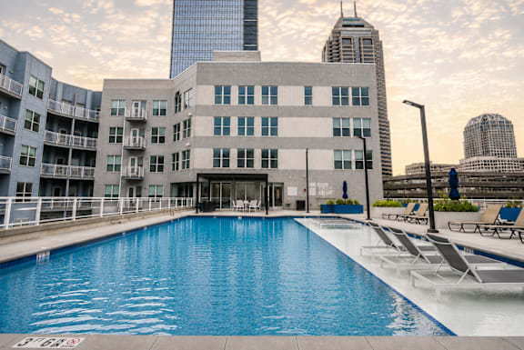 A large swimming pool in front of a modern building.