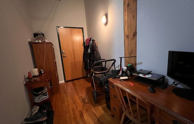 a room with a desk and a chair and a door