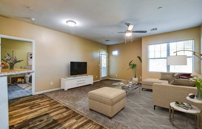 A living room with a flat screen TV and a couch.
