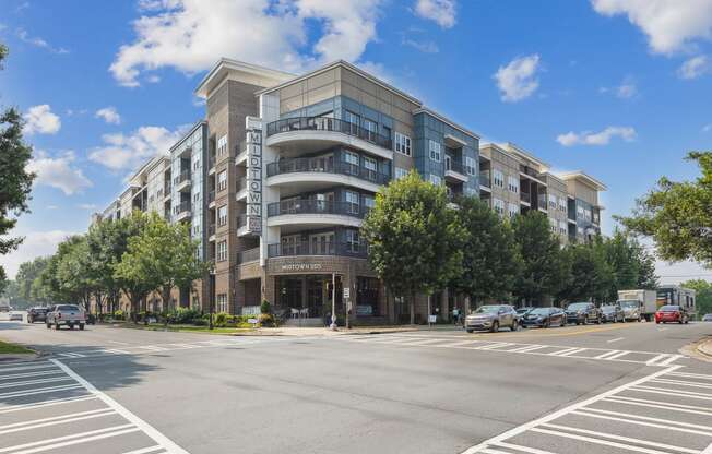 a large apartment building with balconies and a sign on the side of the building that reads