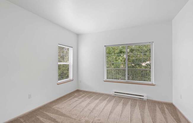 a room with white walls and a large window