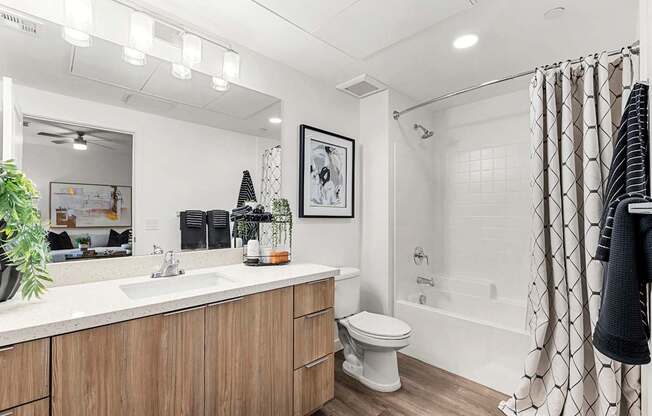 A bathroom with a white sink and a white toilet.
