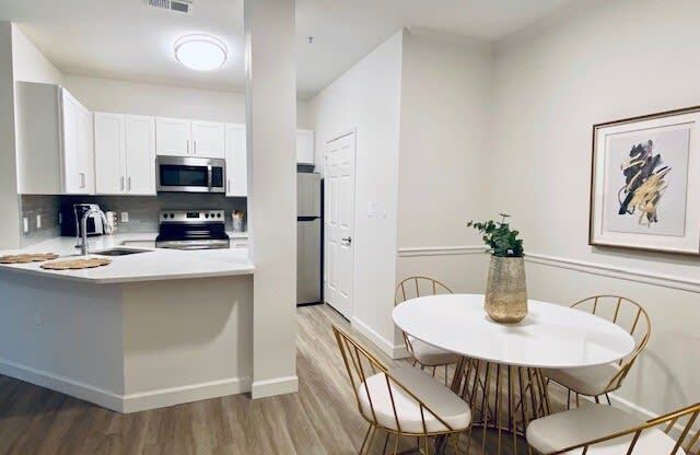 kitchen and dining room with a table and chairs at Mainstreet Apartments, Clearwater, 33756