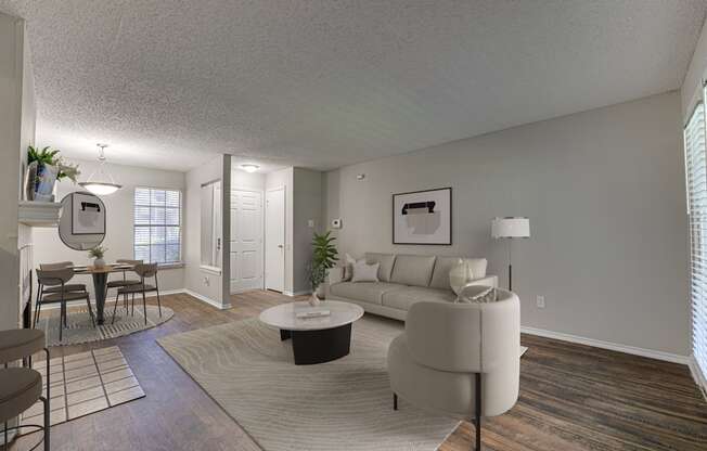 A living room with a couch, chairs, and a coffee table.