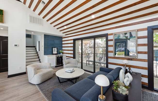 Clubhouse with a blue couch and a coffee table at Maxwell Townhomes, San Antonio, 78230