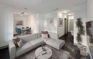 a living room with a white couch and a glass coffee table