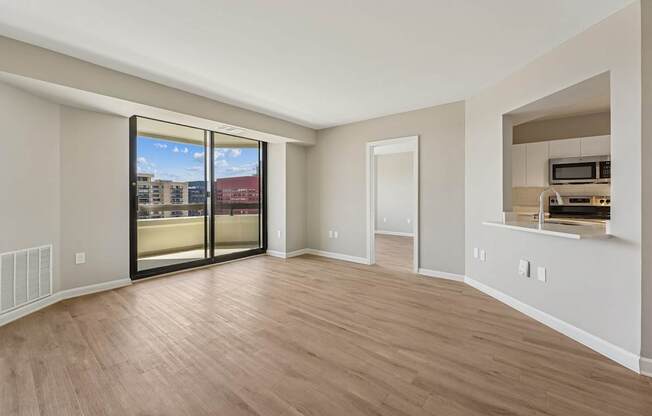 Inviting living room with a sliding glass door leading to a balcony.