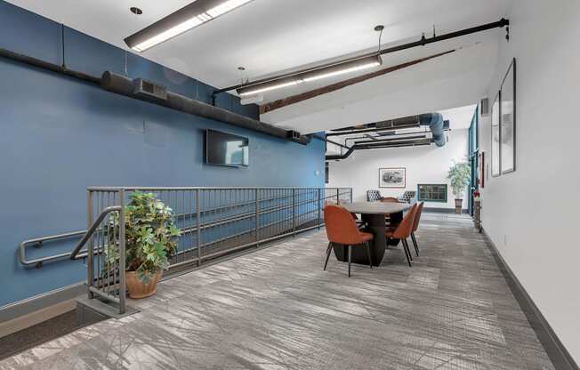 A room with a blue wall and a table with chairs.
