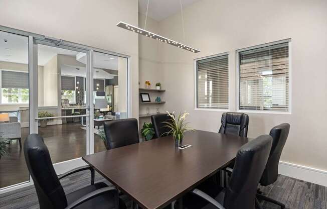 A conference room with a long table and chairs.