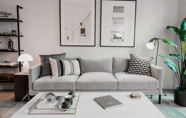 a living room with a couch and a coffee table at The Lively, Jersey City, 07302