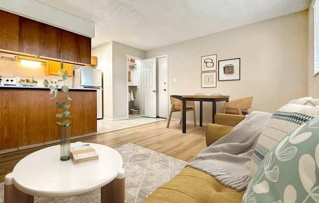Warm-toned living and dining area with updated floors in Aurora Meadows rental.