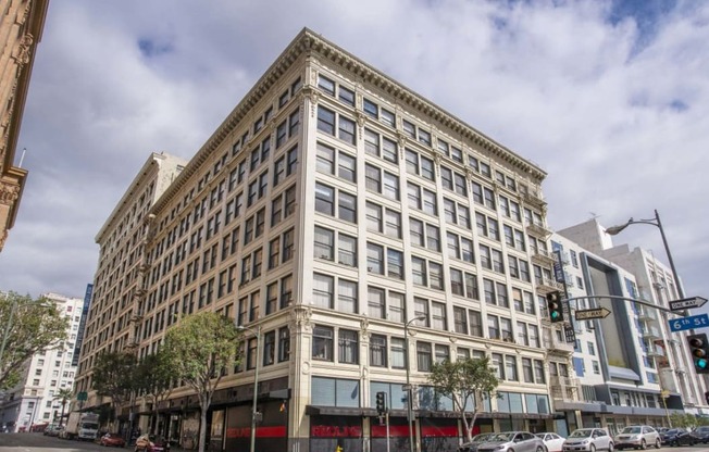 a large white building with many windows and a red awning