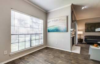 a living room with a large window and a couch and a table