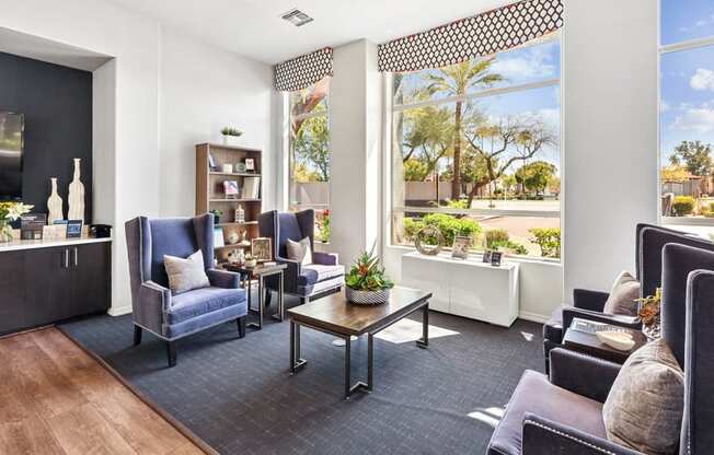 A living room with a dark blue sofa and a wooden coffee table.