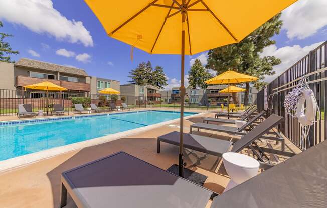 Fremont Apartments for Rent-Metro Fremont Apartments Large Gated Pool Lined With Lounge Chairs And Umbrellas