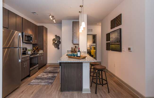 a kitchen with a large island and stainless steel appliances at The Whitworth, Williamsburg, VA, 23185