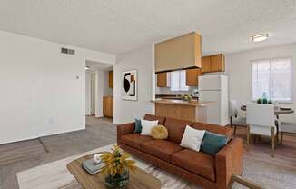 A living room with a brown couch and a coffee table.