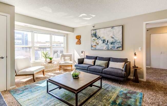 a living room with a large window and a couch