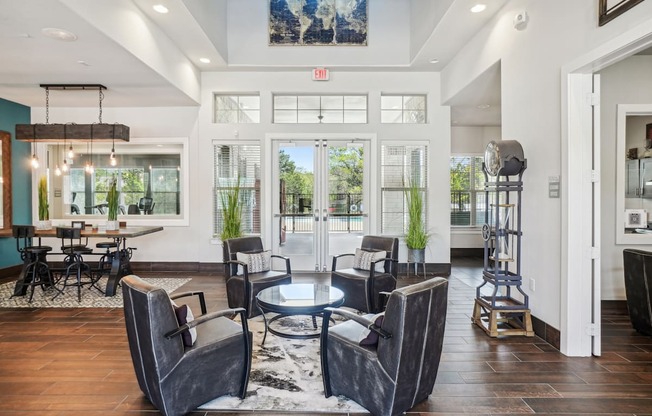 A modern living room with a glass door entrance and a dining area.
