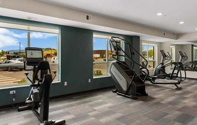 A gym with treadmills, elliptical machines, and a rowing machine.