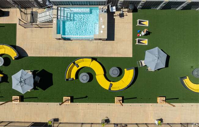 an aerial view of a swimming pool with umbrellas